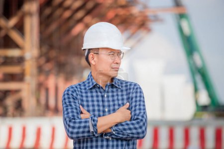 Photo for Engineer man checking project at the building site, Man in hardhat at infrastructure construction site - Royalty Free Image