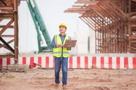 Photo for Engineer man with laptop at construction site, Foreman worker checking project in building site - Royalty Free Image
