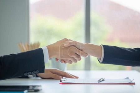 Photo for Close-up of business people shaking hands in the office. Finishing successful meeting. The businessman and businesswoman handshake after the meeting - Royalty Free Image