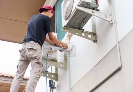 Photo for Air Conditioning Repairman checking and fixing modern air conditioning system, Technician team checking leakage air conditioning system - Royalty Free Image