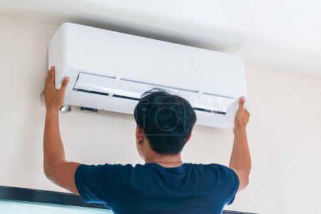 Photo for Technicians install new air conditioners, Repairman service for repair and maintenance of air conditioner - Royalty Free Image