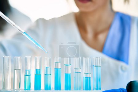Photo for Test tubes with liquid in modern laboratory. Research scientist using pipette filling flasks. Medicine, biotechnology, microbiology Development concept - Royalty Free Image