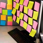 Blank colorful sticky notes reminders on computer monitor. Office workplace, business plan, task