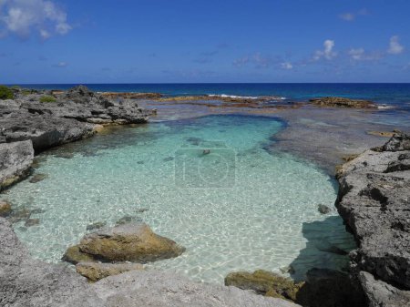 Swimming hole in Rota, Northern Mariana Islands, with a swimmer's feet sticking out of the water.