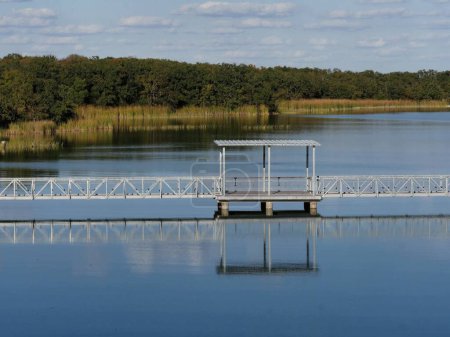 Photo for White bridge with a shed reflected in the waters of Murray Lake in Oklahoma. - Royalty Free Image