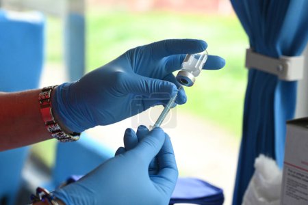 Photo for Lviv, Ukraine - 25, 2023: A nurse prepares a DTaP vaccine in the mobile vaccination point in city of Lviv. - Royalty Free Image