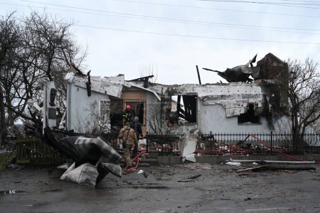 Photo for Lviv, Ukraine - January 1, 2024: Ukrainian firefighters inspect the destroyed building Roman Shukhevych Museum after a Russian drone attack in Lviv. - Royalty Free Image