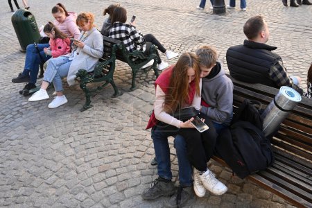 Photo for Lviv, Ukraine - April 23, 2023: A people rest on benches in center the city of Lviv. - Royalty Free Image