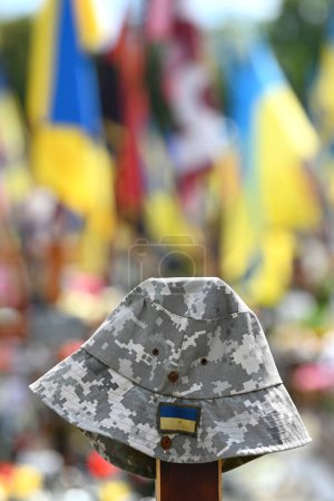 Soldier's hat on the grave at Military cemetery of Ukrainian soldiers killed during combat with Russian troops