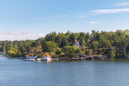 Stockholm Archipelago, view from the cruise ship. Cottages on the shore