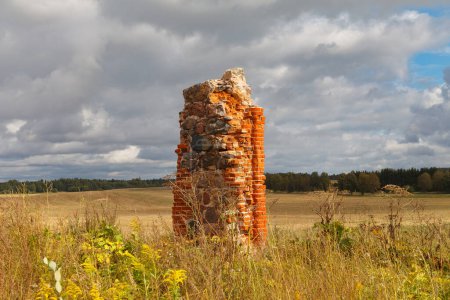 ruins of an old barn made of boulders and red bricks in the middle of a field of cornflowers, an unofficial tourist attraction that resembles the famous Stonehenge in Great Britain, Smiltene, Latvia