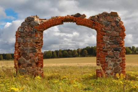 ruins of an old barn made of boulders and red bricks in the middle of a field of cornflowers, an unofficial tourist attraction that resembles the famous Stonehenge in Great Britain, Smiltene, Latvia
