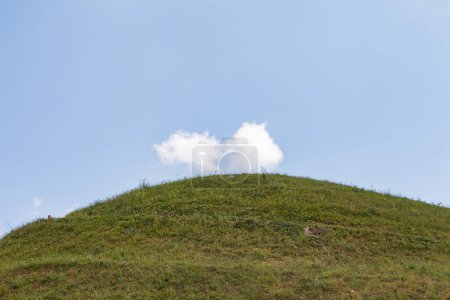 Ideal green round hill and blue sky with clouds above it. Krakus Mound, Krakow, Poland.
