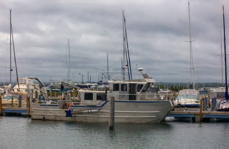 Photo for Several Boats at Mackinaw City Marina in Michigan on a cloudy day. - Royalty Free Image