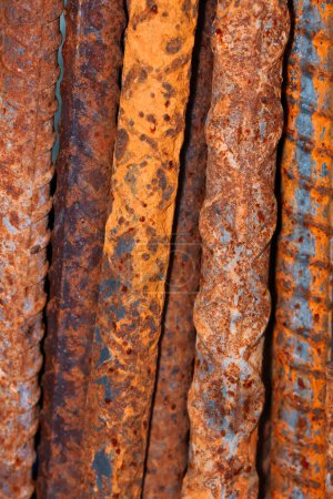 Corroded steel rods pile used in construction, close up view.