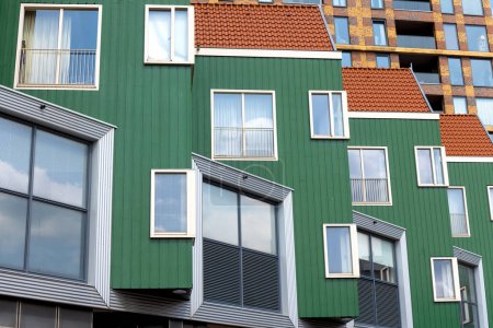 Colorful green and red color modern apartment building exterior view in Zaandam, the Netherlands.