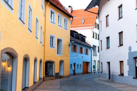 Colorful buildings along a street in historic Fussen, is a small town in Bavaria, Germany.