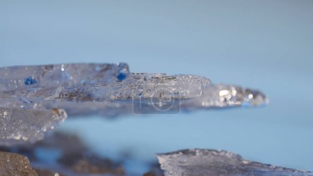 Close up view of ice formation in the blue water during early spring time.