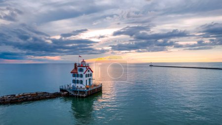 Aerial view of Lorain harbor lighthouse in the middle of lake Erie, under evening sun light.