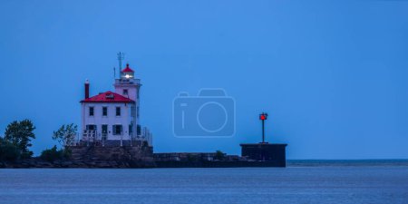 Aerial view of Fairport harbor west breakwater light house in the middle of Lake Erie in blue hour.
