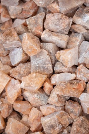 Close up view of pink mineral rocks up for sale in the market.