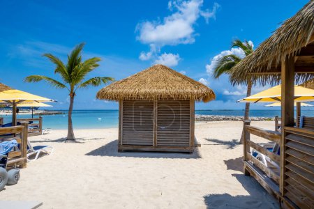 Cabanas on white sand beach in Caribbean islands.