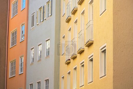 Colorful tall Bavarian style apartment buildings in Landsberg city Germany built close to each other.