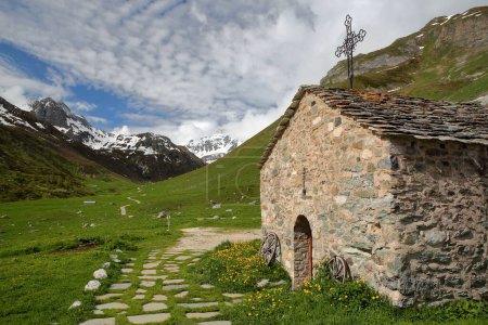 Photo for A chapel surrounded by mountains, located next to Roc de la Peche hut along the Chaviere valley, Pralognan la Vanoise,Vanoise National Park, Northern French Alps, Tarentaise, Savoie, France - Royalty Free Image