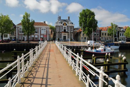 Photo for Historic buildings and the Stadhuis (Town Hall) viewed from the Raadhuisbrug bridge in Noorderhaven, Harlingen, Friesland, Netherlands - Royalty Free Image