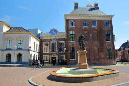 Photo for The Stadhuis (Town Hall, dated from 1715), located on Hofplein Square in Leeuwarden, Friesland, Netherlands, with the statue of Willem Lodewijk van Nassau (inception date 1906) in the foreground - Royalty Free Image