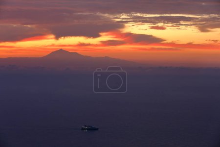 Photo for El Teide volcano (Tenerife island) viewed at sunrise from Puntallana, located on the Eastern coast of La Palma, Canary Islands, Spain - Royalty Free Image