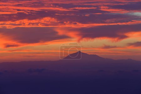 Photo for El Teide volcano (Tenerife island) viewed at sunrise from Puntallana, located on the Eastern coast of La Palma, Canary Islands, Spain - Royalty Free Image