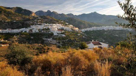 General view of the village Frigiliana, Axarquia, Malaga province, Andalusia, Spain, with surrounding mountains (National Park Sierra de Tejada, Almijara y Alhama)  and with whitewashed houses