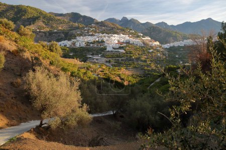 General view of the village Frigiliana, Axarquia, Malaga province, Andalusia, Spain, with surrounding mountains (National Park Sierra de Tejada, Almijara y Alhama)  and with whitewashed houses