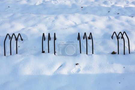 Photo for A winter landscape with metal bicycle holders covered in snow - Royalty Free Image