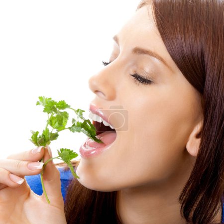Photo for Cheerful woman eating potherbs, isolated over white background - Royalty Free Image