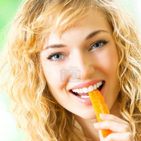 Foto de Retrato de una joven feliz comiendo zanahorias - Imagen libre de derechos
