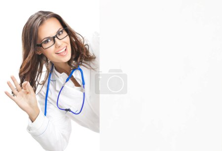 Photo for Portrait of happy smiling young female doctor showing blank signboard, with okay gesture, isolated over white background - Royalty Free Image