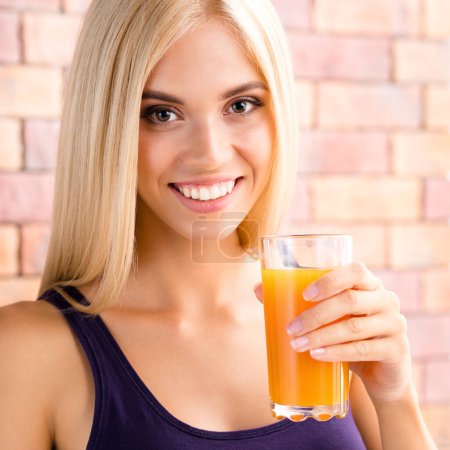Photo for Portrait of happy smiling young beautiful blond woman drinking orange juice. Healthy eating, beauty and dieting concept. - Royalty Free Image