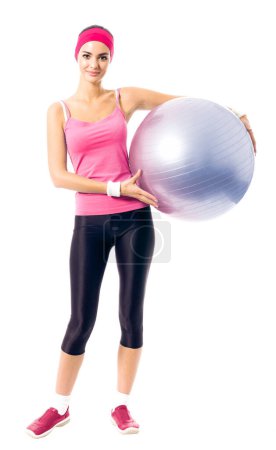 Photo for Young happy woman in red sportswear with fitness ball, isolated on white - Royalty Free Image