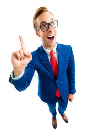 Foto de ¡Tengo una idea! Retrato de cuerpo completo de divertido joven empresario feliz en traje azul y corbata roja, que aparece por el dedo índice, plano de vista de ángulo superior, aislado contra fondo blanco. Concepto empresarial. - Imagen libre de derechos