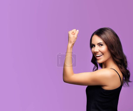 Photo for Portrait of cheerful smiling young woman happy gesturing, over violet background, with blank copyspace area for slogan or text - Royalty Free Image