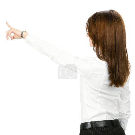 Foto de Joven mujer de negocios señalando algo en su espalda, aislada sobre fondo blanco - Imagen libre de derechos