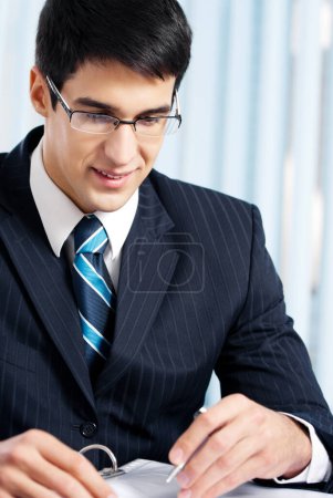 Foto de Retrato de la escritura sonriente hombre de negocios trabajando en la oficina - Imagen libre de derechos