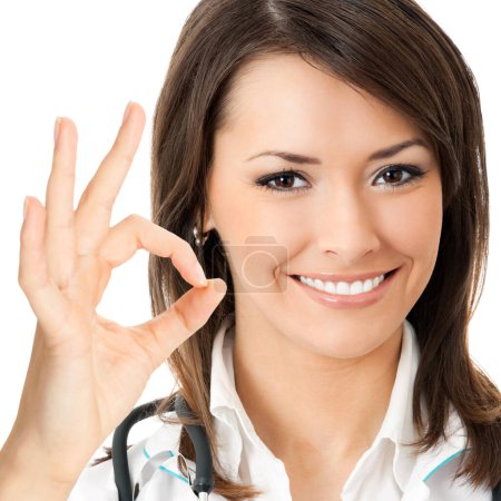 Portrait of cheerful doctor showing okay gesture, isolated over white background
