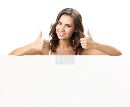 Photo for Happy smiling beautiful young woman showing blank signboard with copyspace for some text, advertising or slogan, isolated against white background - Royalty Free Image