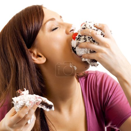 Photo for Cheerful young woman eating pie, isolated against white background - Royalty Free Image
