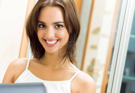 Photo for Smiling beautiful woman working with laptop, at home - Royalty Free Image
