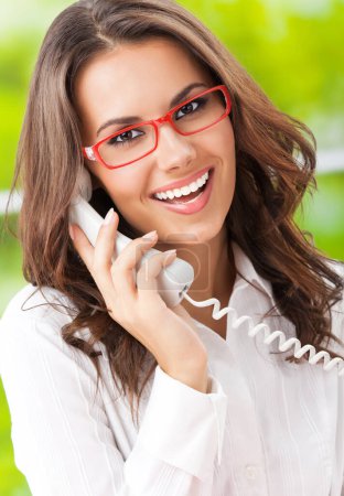 Photo for Portrait of happy smiling young businesswoman or support phone worker, at office - Royalty Free Image