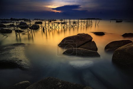 Téléchargez les photos : Une vue sur le coucher du soleil sur la plage de Tamjung Kelayang / Belitung- Indonésie / - en image libre de droit